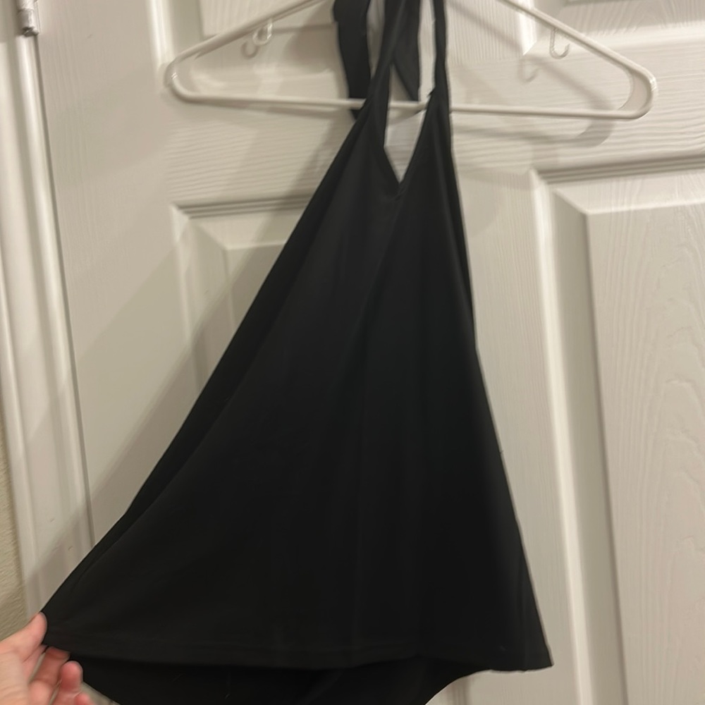 Black halter top, toes around neck